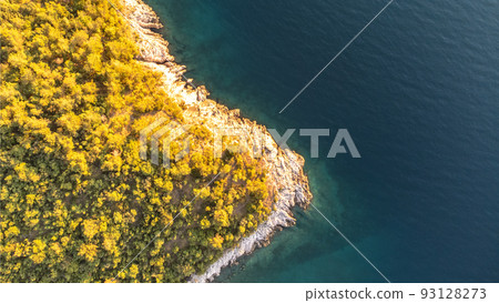 Rocky cliffs and blue sea on sunny summer day Rocky cliffs and blue sea on sunny summer day 93128273