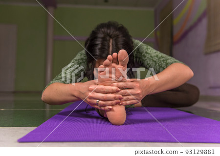 Yoga female demonstrating yoga asana in a studio Yoga female demonstrating yoga asana in a studio 93129881