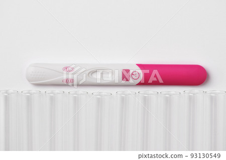 Positive pregnancy test with laboratory test tube. In vitro fertilization, artificial insemination and infertility treatment concept. 93130549