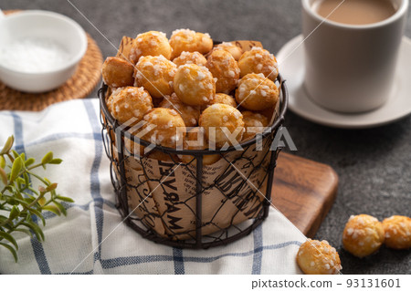 Delicious French Chouquette Choux Pastry dessert Pearl Sugar Puff on gray table background. 93131601