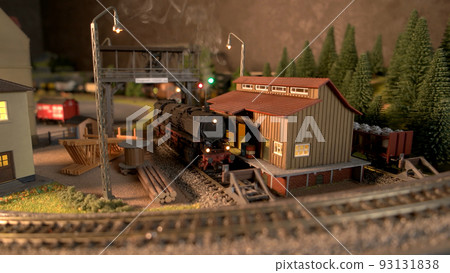 Model railway station with moving model locomotive. Toy diesel locomotive driving on railroad. Model railway exhibition. Model railway station with moving model locomotive. Toy diesel locomotive driving on railroad. Model railway exhibition. 93131838