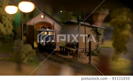 Toy diesel railway engine at depot station. Scale model railway layout with diesel locomotive. 93131850