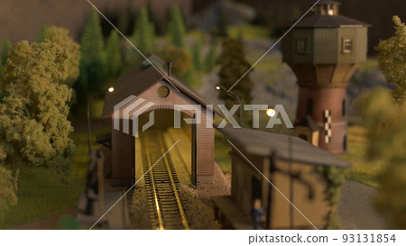 Depot station on the model of the railway road. Model train station at miniature forest. Depot station on the model of the railway road. Model train station at miniature forest. 93131854