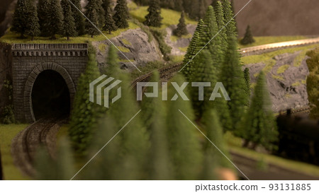 Railway tunnel among fir trees in mountains. Railway modelling in Europe. Railway tunnel among fir trees in mountains. Railway modelling in Europe. 93131885