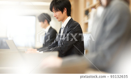 A business person in a suit typing on a PC A business person in a suit typing on a PC 93132635