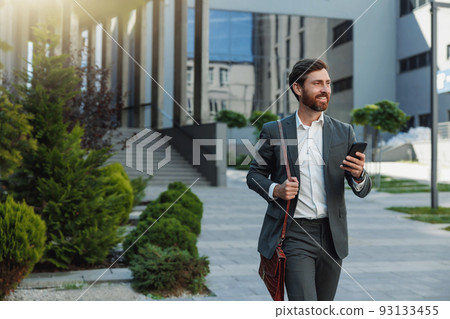 Satisfied Businessman in suit going home after long working day and looking at side Satisfied Businessman in suit going home after long working day and looking at side 93133455