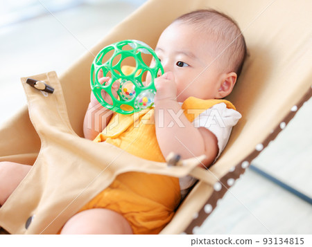 baby playing alone with toys 93134815
