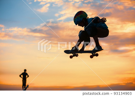 Skateboarder in action. Boy making skate air trick with grab Skateboarder in action. Boy making skate air trick with grab 93134903