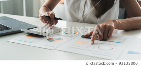 business woman or accountant working on calculator to calculate business data, accountancy document and laptop computer at office, business concept 93135800