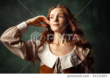 Portrait of charming redhair girl with long curly hair like girl of renaissance eras, lady-peasant isolated on dark background. Eras comparison, beauty, art, Portrait of charming redhair girl with long curly hair like girl of renaissance eras, lady-peasant isolated on dark background. Eras comparison, beauty, art, 93135803