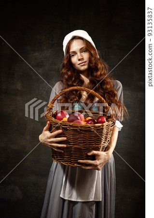Vintage style. Young charming redhair girl with long curly hair like girl of renaissance eras isolated on dark background. Eras comparison, beauty, art, painting Vintage style. Young charming redhair girl with long curly hair like girl of renaissance eras isolated on dark background. Eras comparison, beauty, art, painting 93135837