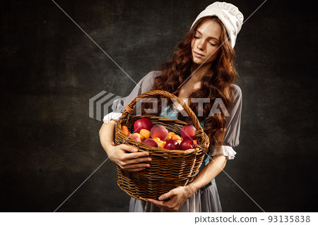 Portrait of charming redhair girl with long curly hair like girl of renaissance eras, lady-peasant isolated on dark background. Eras comparison, beauty, art, 93135838