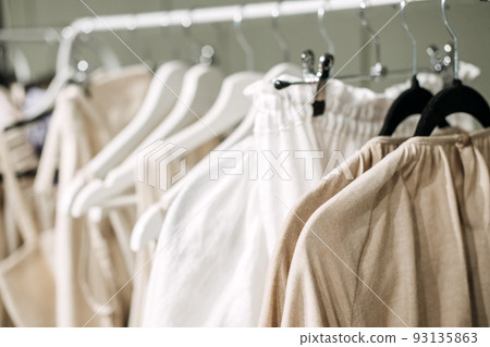 Sustainable fashion, slow fashion. Close Up Shot of Clothing Rack with natural tones clothes Sustainable fashion, slow fashion. Close Up Shot of Clothing Rack with natural tones clothes 93135863