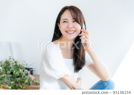 Young woman talking on a smartphone Young woman talking on a smartphone 93136154