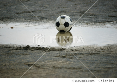 soccer ball in puddle 93136164