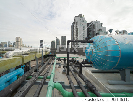 Chiller tower or cooling tower on rooftop of a office building in urban city. System work. Architecture machine. Condenser Water Supply and Condenser Water Return pipe lines. Ventilation compressor. 93136312
