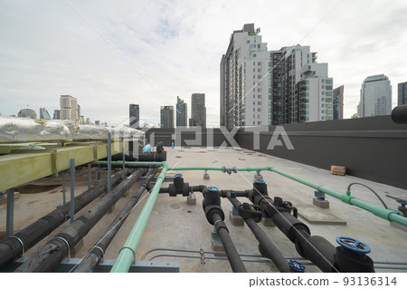 Chiller tower or cooling tower on rooftop of a office building in urban city. System work. Architecture machine. Condenser Water Supply and Condenser Water Return pipe lines. Ventilation compressor. 93136314