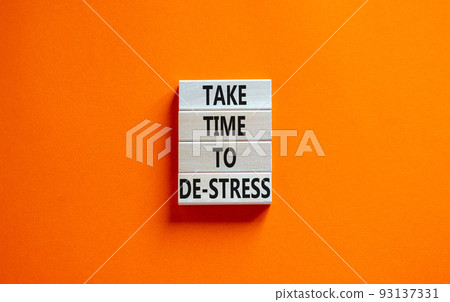 Take time to de-stress symbol. Concept words Take time to de-stress on wooden blocks. Beautiful orange table orange background. Psychological business and take time to de-stress concept. Copy space. 93137331