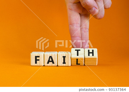 Faith instead fail symbol. Businessman turns wooden cubes and changes the concept word Fail to Faith. Beautiful orange table orange background. Business and faith instead fail concept. Copy space. 93137364