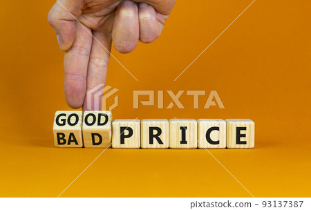 Good or bad price symbol. Businessman turns wooden cubes and changes words 'bad price' to 'good price'. Beautiful orange table, orange background, copy space. Business and good or bad price concept. 93137387