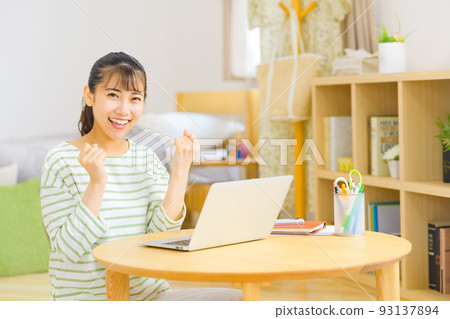 Teleworking young business woman doing desk work at home Teleworking young business woman doing desk work at home 93137894