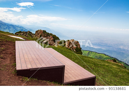 Observation deck on the top of the mountain for hikers at the Kok Zhailau tract and the city of Almaty Observation deck on the top of the mountain for hikers at the Kok Zhailau tract and the city of Almaty 93138681