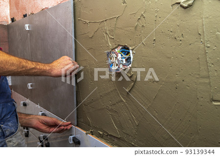 adhesive, architecture, bathroom, bathroom renovation, builder, building, cement, ceramic tile laying, ceramic wall tiles, concrete, construction, construction worker, contractor, cuts tile, decoratio 93139344