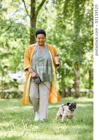 Black Woman Walking Dog in Park 93139520