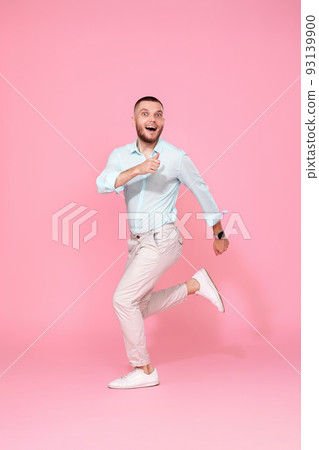 man in summer clothes jumping on pink background. man in summer clothes jumping on pink background. 93139900