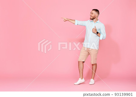 friendly smiling man in blue shirt pointing on copy space friendly smiling man in blue shirt pointing on copy space 93139901