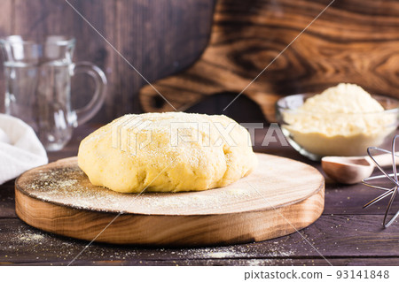 Ready raw dough for baking mexican tortillas on the board on the table. Homemade pastries 93141848