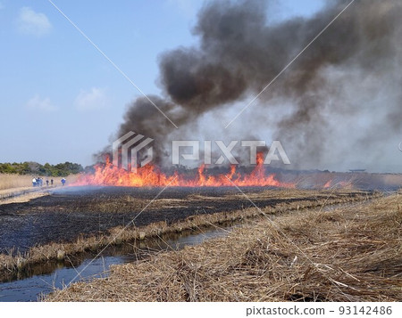 People watching Yoshiyaki with burning flames and black smoke People watching Yoshiyaki with burning flames and black smoke 93142486