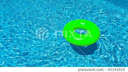 Light green ring floating in blue swimming pool. Inflatable ring, rest concept Light green ring floating in blue swimming pool. Inflatable ring, rest concept 93143020