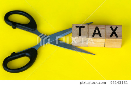 Scissor cutting wooden blocks with text TAX. Cutting tax expenses concept. Scissor cutting wooden blocks with text TAX. Cutting tax expenses concept. 93143181
