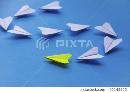 Yellow paper plane origami leading white planes on blue background. Leadership skills concept Yellow paper plane origami leading white planes on blue background. Leadership skills concept 93143225