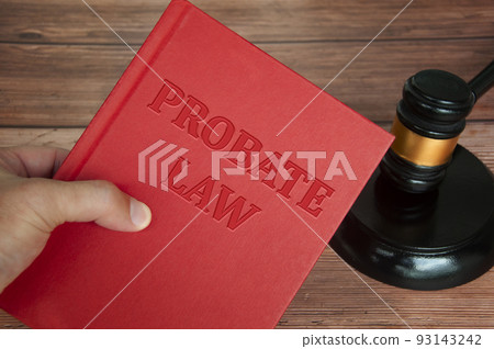 Hand holding Probate Law book with gavel background. Law concept 93143242