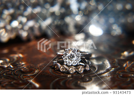 Two wedding rings on the reflecting surface with highlights 93143473