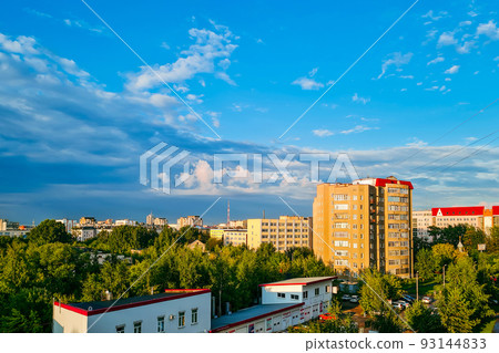 Aerial view of suburbs. Residential buildings in sun against blue sky. Aerial view of suburbs. Residential buildings in sun against blue sky. 93144833