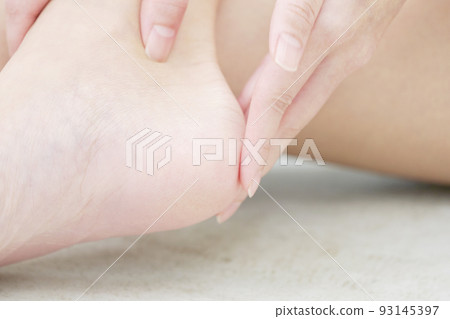 Close-up of a woman taking care of heels 93145397