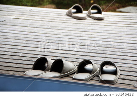 Slippers lined up on the porch 93146438