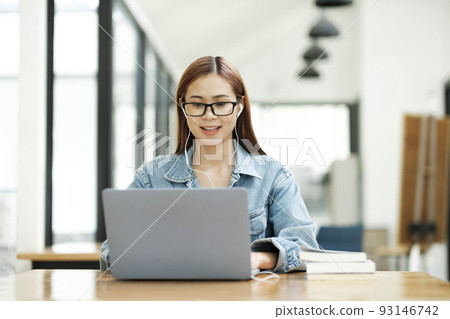 Young woman study in front of the laptop computer at home. Young woman study in front of the laptop computer at home. 93146742