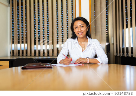 Young adult woman working in meeting room Young adult woman working in meeting room 93148788