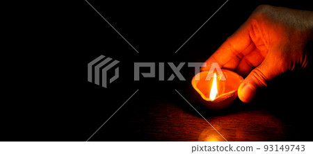 Diwali lamp lit by hand, Diwali Lamps , Diwali diya lamps lit during diwali celebration 93149743