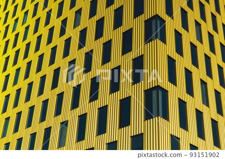 Modern office building exterior with glass facade on clear sky background. Transparent glass wall of office building with yellow decoration. Element of facade of modern European building Commercial Modern office building exterior with glass facade on clear sky background. Transparent glass wall of office building with yellow decoration. Element of facade of modern European building Commercial 93151902