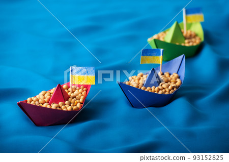 Boats with Ukrainian soybeans made of paper origami concept Boats with Ukrainian soybeans made of paper origami concept 93152825
