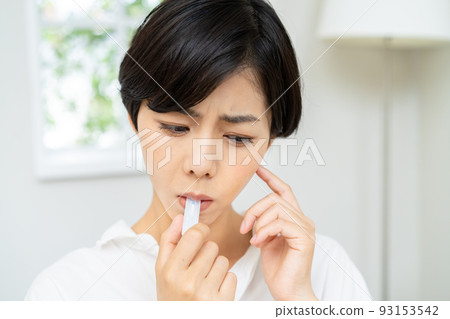 Woman doing an antigen test PCR test Woman doing an antigen test PCR test 93153542