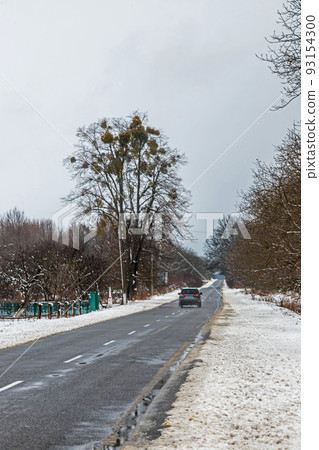 driving in winter after a snowfall, ice on the road, temperatures below zero driving in winter after a snowfall, ice on the road, temperatures below zero 93154300