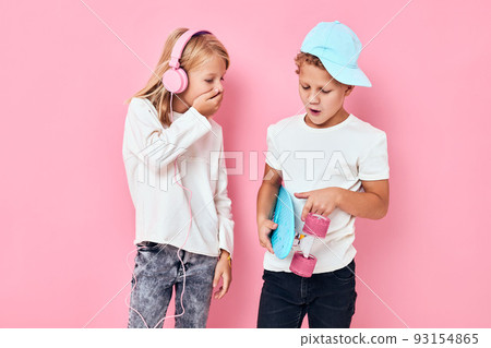 Portrait of two young smiling kids happy faces blue isolated background Portrait of two young smiling kids happy faces blue isolated background 93154865