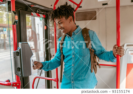 Guy holding card to reader on bus Guy holding card to reader on bus 93155174