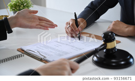 Cropped view of attorney or lawyers talking to her clients for providing law consultation and legal advice 93156671